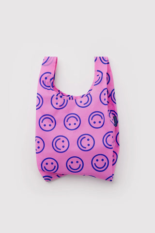 Baby BAGGU pop pink reusable tote bag with smiley face pattern