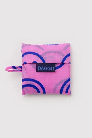 Baby BAGGU foldable pouch with smiley print and BAGGU logo tab