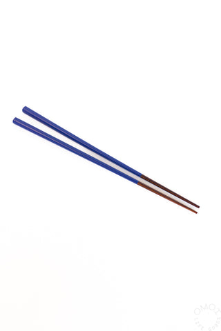 Pair of blue chopsticks on a white background