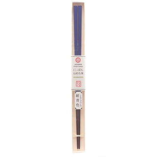 Pair of blue chopsticks in a box with a label on a white background
