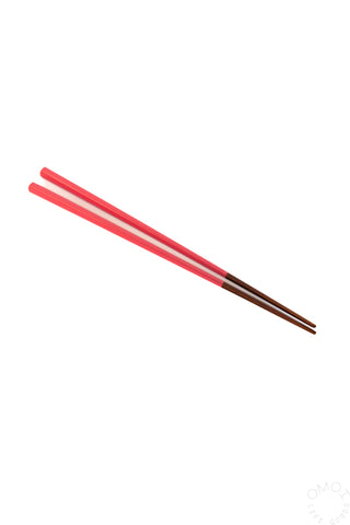Pair of red chopsticks on a white background