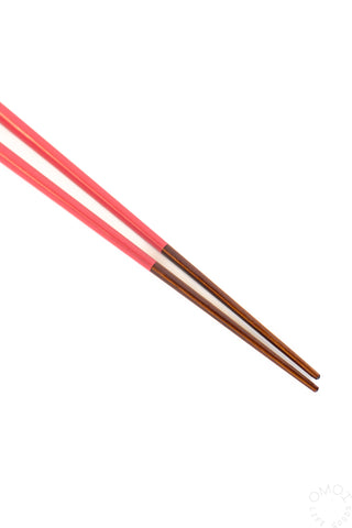 Pair of red chopsticks on a white background