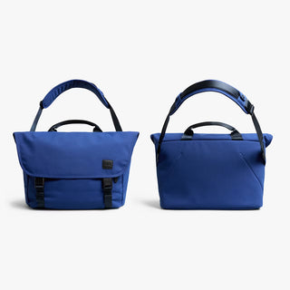 Two blue messenger bags showing front and back with black accents on a white background