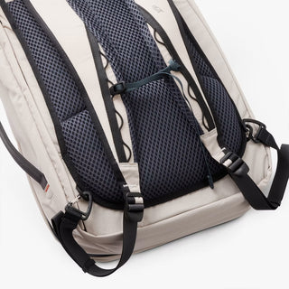 Close-up of a beige backpack with black straps on a white background
