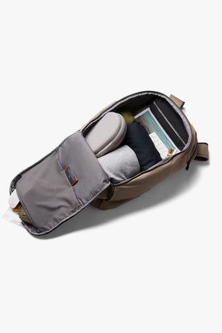 An open backpack shown from a top-down angle, revealing its interior compartments, padded inserts, and storage pockets, against a white background.