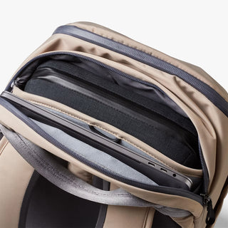 Open workpack front pocket with padded dividers and elastic bands for devices.