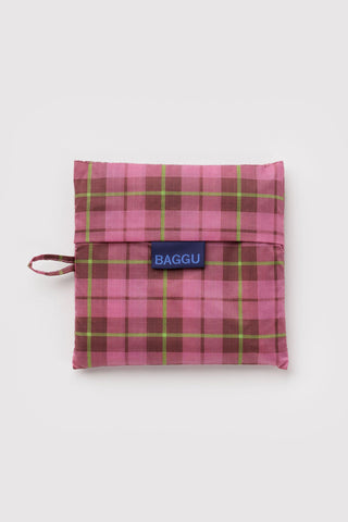 folded pink and green tartan patterned baggu tote bag on a light background