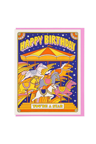 birthday greeting card featuring a colorful carousel illustration with the text 'HAPPY BIRTHDAY' and 'YOU'RE A STAR',