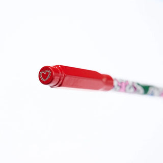 Red pencil guard with a heart design on the cap against a white background