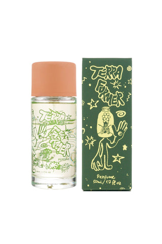 Perfume bottle with green label next to its packaging on a white background