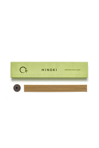 Hinoki incense packaging with incense sticks and a holder on a white background