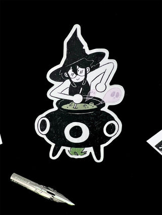 Cartoon witch character stirring a pot with a pen for scale on a black background