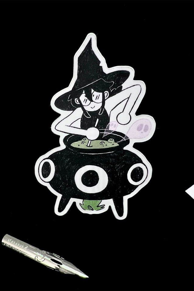 Cartoon witch character stirring a pot with a pen for scale on a black background