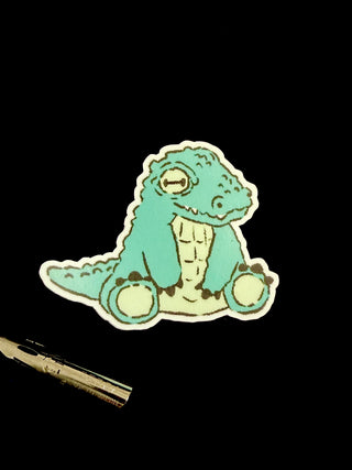 Cartoon dinosaur sticker on a black background