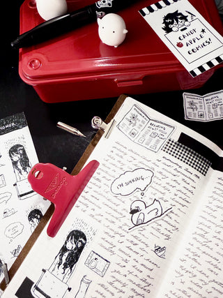 Artistic illustrations on paper with a red toolbox and stationery items.