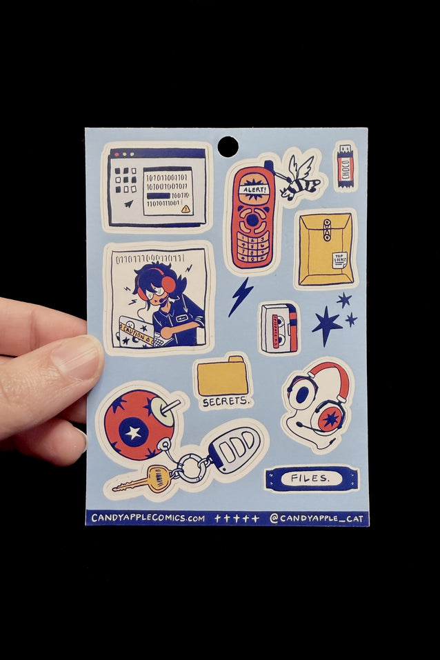 Sheet of stickers held by a hand with a black background