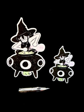 Two stickers with the same witch's brew design comparing sizes, one smaller one larger