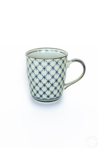 Ceramic mug with blue geometric pattern on a white background
