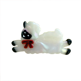 Hair clip with a sheep design and a red bow