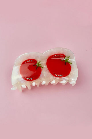 Hair clip with tomato design on a pink background