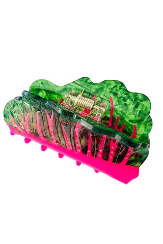Green and pink hair clip on a white background