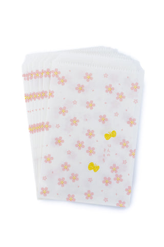 White paper bags with floral pattern on a white background