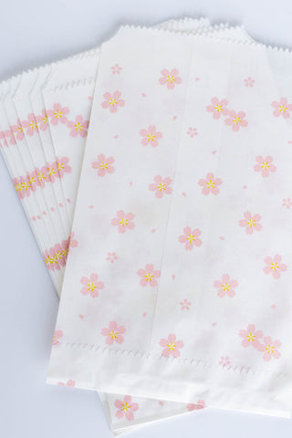 Set of white flat bags with pink floral patterns on a white background