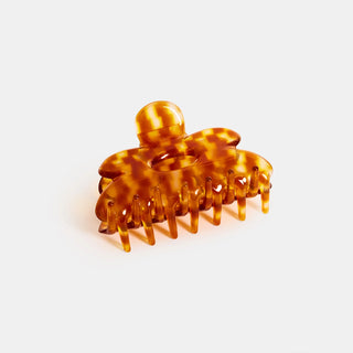 Tortoiseshell hair clip on a light gray background