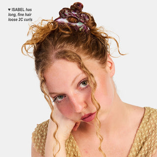 Woman with colorful hair clip against a white background
