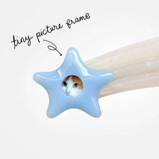 close up of shooting star hair clip with a tiny picture frame, inside a tiny photo of a cat