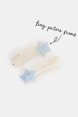 two star shaped hair clips with a tiny cut out picture frame hole in the star