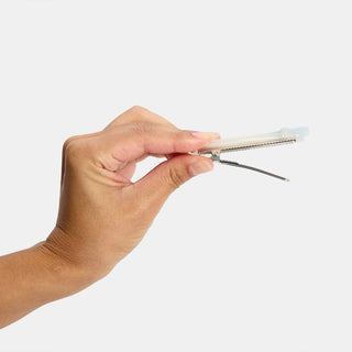 person holding open hair clip 