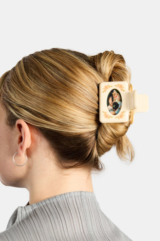 Person with hair clip with a photo frame on a white background