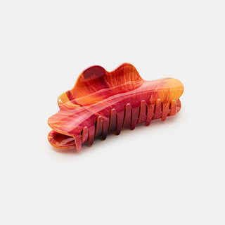 Red and orange hair clip on a white background