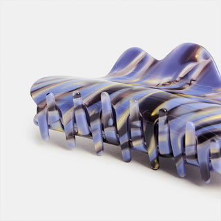 Marbled purple and gray hair clip on a white background