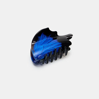 Black hair clip with blue swallowtail butterfly design on a white background