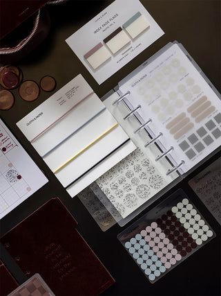 Stationery palette swatches and binders laid out with metallic ring travel cover