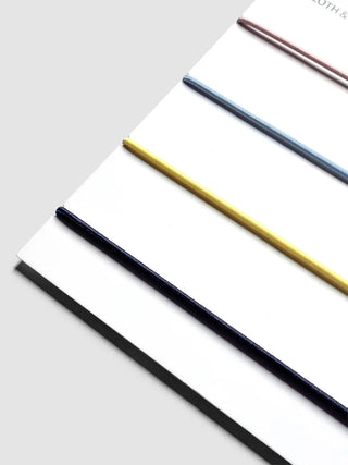 Travel cover exterior bands in navy, yellow, and black over white cloth backing