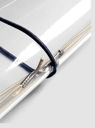 Close-up of travel cover elastic bands with silver metal rings and stitched edges