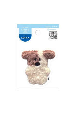 Small sticker of a plush dog toy on a white background with a blue label