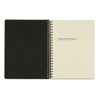 Opened notebook planner with spiral binding on a white background