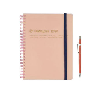 Pink planner with a pen on a white background