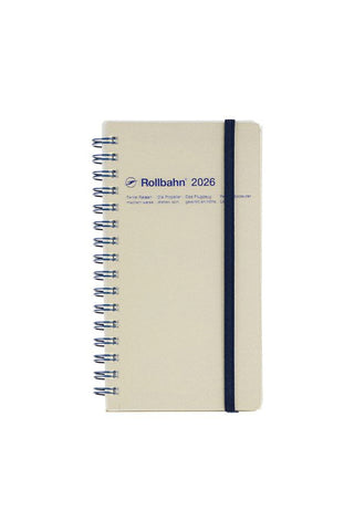 Beige notebook with spiral binding and 'Rollbahn' branding on a white background