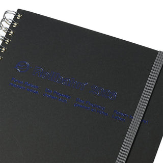 Black notebook with spiral binding and Rollbahn branding on a white background