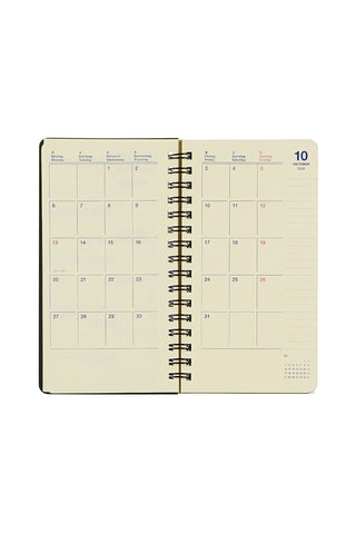 Spiral-bound planner with monthly calendar layout on a white background
