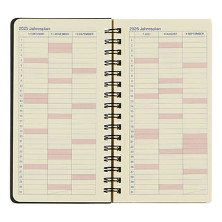 Open spiral-bound planner showing calendar pages for 2025 and 2026 on a white background.