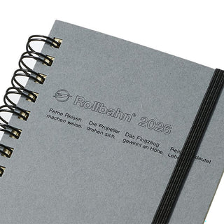 Gray notebook with 'Rollbahn' branding and black details on a white background