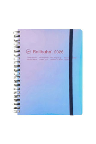 Spiral-bound notebook with gradient cover and 'Rollibahn 2026' branding on a white background