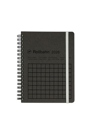 Black spiral-bound notebook with grid pattern on a white background