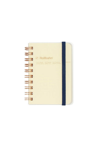 gold spiral notebook with dark blue band, clear cover, and yellow pages